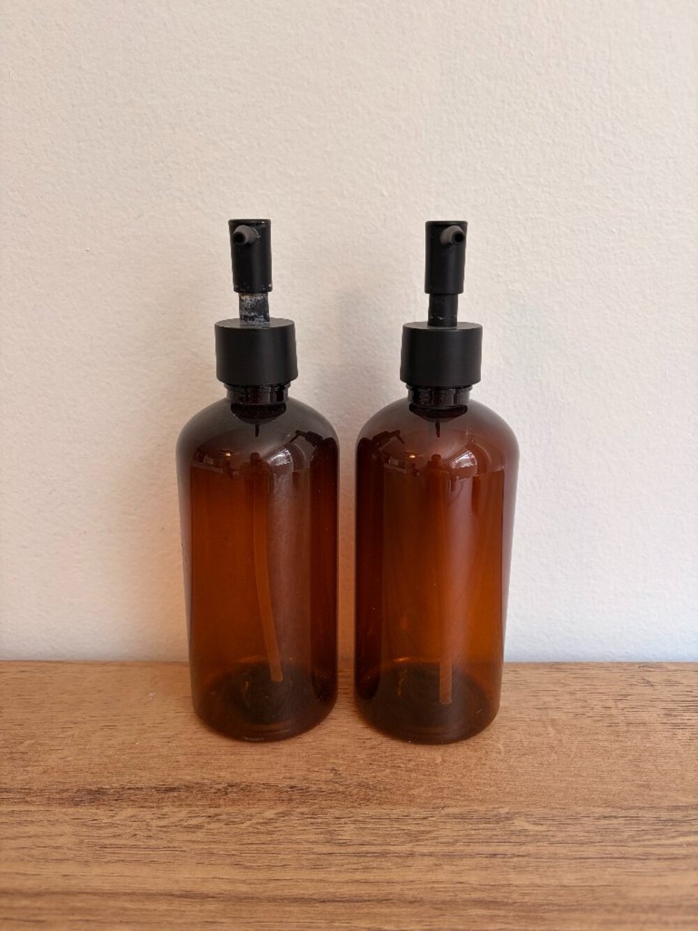 Pair of Amber Plastic Pump Bottles